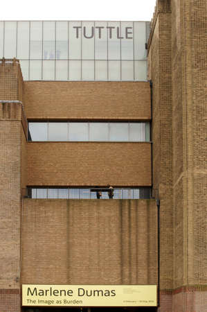 London, UK - March 31, 2015: A large exhibition sign hanging from a terrace of the Tate Modern Museum in London where visitors enjoy the view on March 31, 2015 in London.のeditorial素材