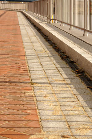 A railing Which a walkway limited casting a shadow.の写真素材