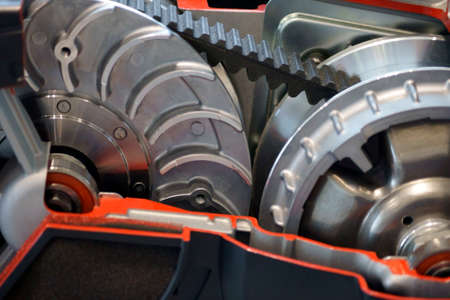 The closeup of the timing belt of a modern engine block.