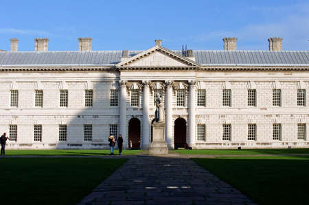 London UK November 29 2014: Visitors stand on a grassy area and visit a building of the Royal Naval College in Greenwich on November 29 2014 in London.のeditorial素材