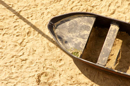 The aerial view and top view of a sandy beach with an old rowboat made of sheet metal.の写真素材