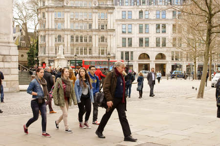 London United Kingdom March 31 2015: Pedestrians walk on the St. Paul39s Churchyard and coming from the St Paul39s Cathedral to cross a sidewalk on March 31 2015 in London.のeditorial素材