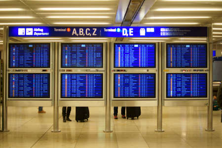 Frankfurt Germany November 27 2014: Travelers standing and waiting at the digital display and information board for departures in the Frankfurt Airport on November 27 2014 in Frankfurt.のeditorial素材