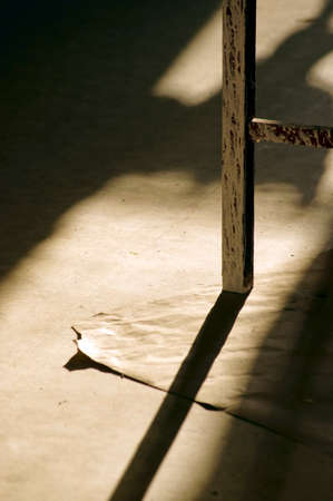 A table leg on a backing casts a shadow.の写真素材