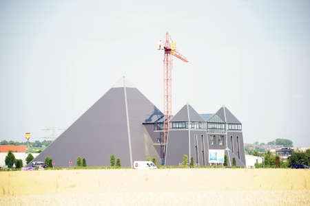 Mainz, Germany - July 03, 2015: The pyramid-like building of the Hotel Ibis Mainz in strong sunlight with at Adjacent crane on July 03, 2015 in Mainz.のeditorial素材