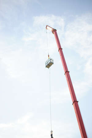 A man has made a bungee jump in use of a crane with a cabin.の写真素材