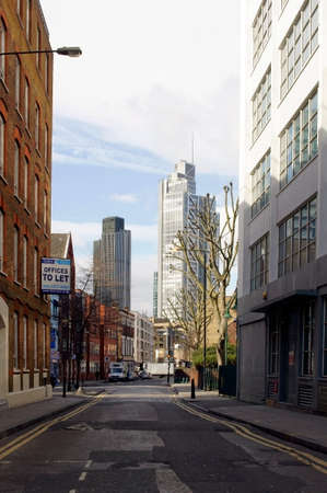 London, UK - March 31, 2015: The Commercial Street in the City of London with office buildings and...