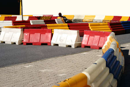 A racer in a kart driving on a limited kart track through the curve.の写真素材