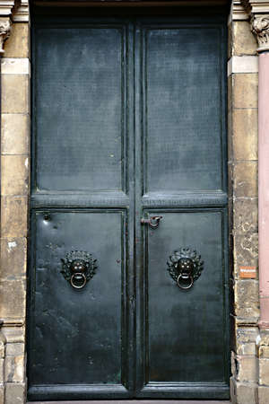 Mainz, Germany - September 04, 2015: The heavy iron door of the entrance to the Mainz Cathedral engraved with Latin words on September 04, 2015 in Mainz.のeditorial素材