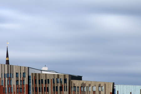 Hamburg, Germany - September 22, 2014: Modern and abstract architecture in the port of Hamburg with the spire of St. Catherine's Church above the roofs on September 22, 2014 in Hamburg.のeditorial素材