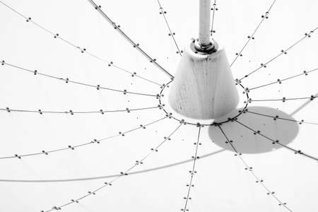 The closeup of the surface of a satellite dish with shadows and screws..の写真素材
