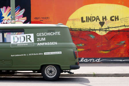 Berlin, Germany - June 16, 2014: An old Barkas of DDR Museum is facing a work of art of the East Side Gallery on June 16, 2014 in Berlin.のeditorial素材