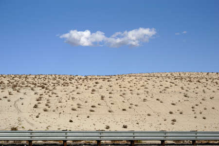 A single cloud over the sand hills in the desert near Yucca Valley.の写真素材