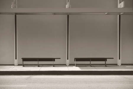 A modern bus station with a canopy and benches.の写真素材