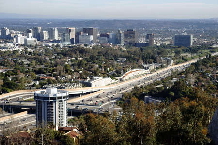 Los Angeles, United States - December 27, 2015: The skyline of Los Angeles with different skyscrapers behind the San Diego Freeway on December 27, 2015 in Los Angeles.のeditorial素材