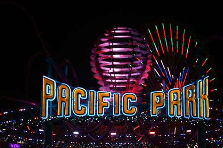 Santa Monica, USA - December 28, 2015: The flashy entrance sign of the amusement area Pacific Park on the Santa Monica Pier at night on December 28, 2015 in Santa Monica.のeditorial素材