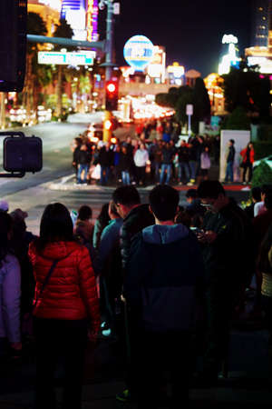 Las Vegas, USA - December 23, 2015: Crowds of tourists are standing at a traffic light on the flashy illuminated Las Vegas Boulevard on the night of December 23, 2015 in Las Vegas.のeditorial素材