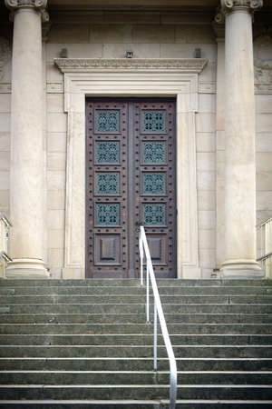 Mainz, Germany - April 07, 2016: The entrance of the old crematory in the main cemetery of the city of Mainz with a heavy iron-studded wooden door on April 07, 2016 in Mainz.のeditorial素材