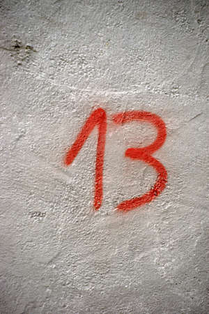 The number 13 sprayed on the wall of a house.の写真素材
