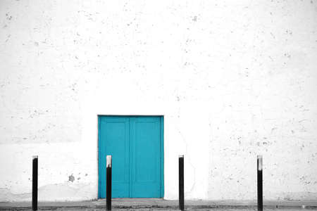 The side entrance to an old in Spanish style built theater with white flaking plaster layers.の写真素材
