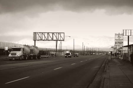 Mojave, United States - December 22, 2015: Road traffic with cars and trucks on the main road and next to the railway tracks on December 22, 2015 in Mojave.のeditorial素材