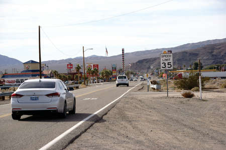 Barstow, United States - December 22, 2015: Traffic with cars on the main road with gas stations, shops and restaurants on December 22, 2015 in Barstow.のeditorial素材