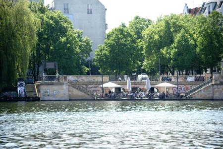 Berlin, Germany - May 09, 2016: Beer garden visitors sit in a beer garden Directly on the banks of the River Spree on May 09, 2016 in Berlin.のeditorial素材