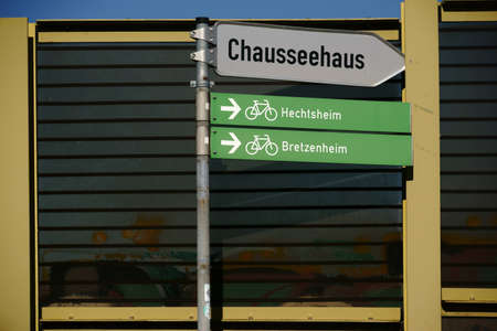 Road signs for bicycle paths and signs are faced with a soundproof wall.の写真素材
