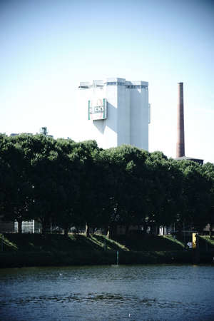Bremen, Germany - August 30, 2016: The Industrial buildings and chimneys of the Becks brewery on the river Weser on August 30, 2016 in Bremen.のeditorial素材