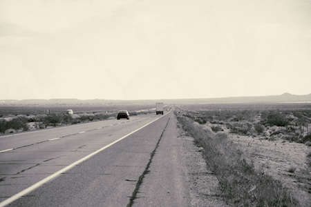 Distant traffic on a highway to Barstow in the Mojave Desert.