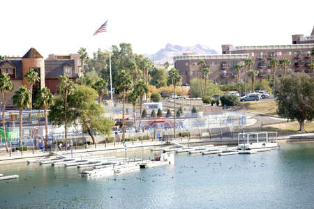 The shores of Lake Havasu with a boardwalk, city views and jetties in Lake Havasu City.の写真素材