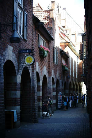 Bremen, Germany - August 30, 2016: Pedestrians with dogs going through the narrow and famous...
