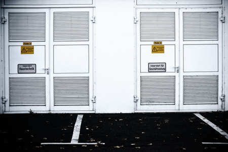 The striking side wall of a shopping center with a steel door to house technology.の写真素材