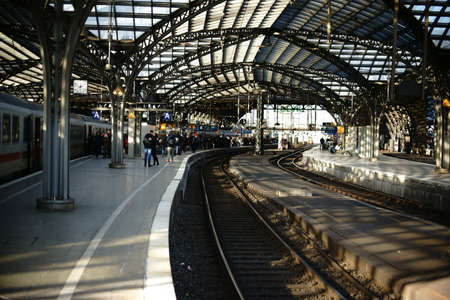 Cologne, Germany - November 24, 2016: Travelers standing on a railway track of the Cologne main railway station under a glass canopy on November 24, 2016 in Cologne.のeditorial素材