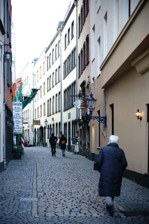 Cologne, Germany - November 24, 2016: Passers-by go up a narrow alley in Cologne's old town on November 24, 2016 in Cologne.のeditorial素材