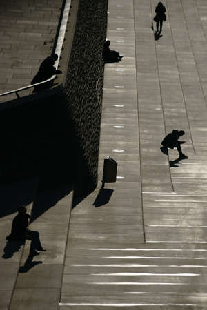 Cologne, Germany - November 24, 2016: The dark silhouettes of pedestrians and passersby on the banks...