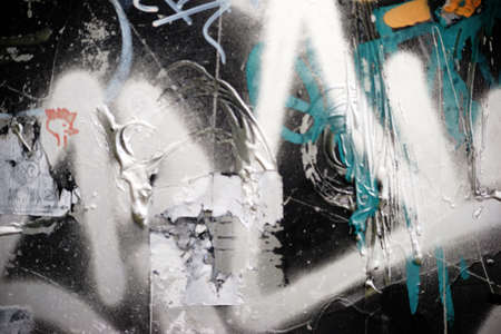 A colorful color background from a surface with textures and structures of color residues and paper remnants.の写真素材