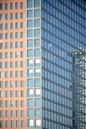 The modern facade of a high-rise building with reflection in the windows.                            の写真素材