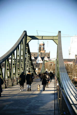 Frankfurt, Germany - January 05, 2017: Visitors crossing the Iron Bridge in direction to the the old town and the Roman Mountain on January 05, 2017 in Frankfurt.のeditorial素材