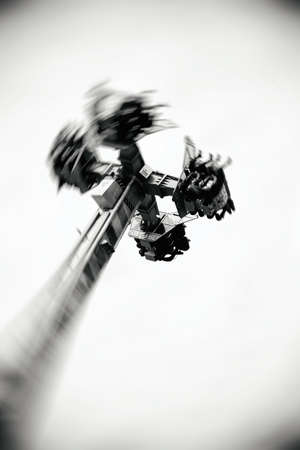 The abstract silhouettes of sits and visitors on a rotating carousel.                             の写真素材