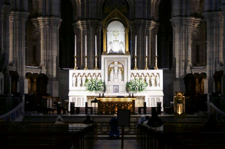 Paris, France - December 29, 2013: People praying at the illuminated altar of the Sacred Heart © -CA "ur Basilica on Montmartre on December 29, 2013 in Paris.のeditorial素材