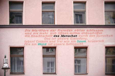 Berlin, Germany - May 01, 2017: A political slogan applied to the facade of a residential building and old building in Berlin Kreuzberg on May 01, 2017 in Berlin.のeditorial素材