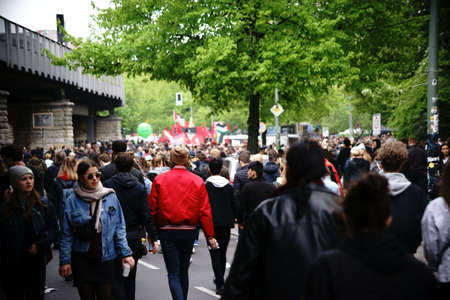 Berlin, Germany - May 01, 2017: Pedestrians, demonstrators and onlookers walking along the subway tracks in Kreuzberg at the annual May 1st demonstration on May 01, 2017 in Berlin.のeditorial素材