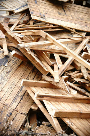 The close-up of debris from rubble and the false ceiling and the beam framework of a roof.の写真素材