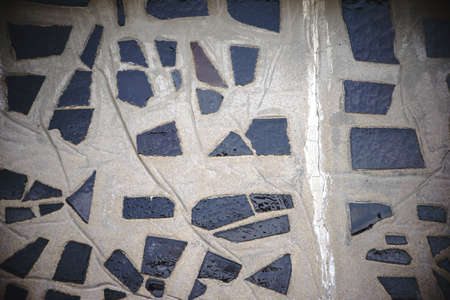 The close-up of a wall made of concrete with embedded chips of glass tile for decoration.の写真素材