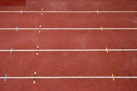 The closeup and oblique perspective on a 100 m running track in a stadium with markers.             ...