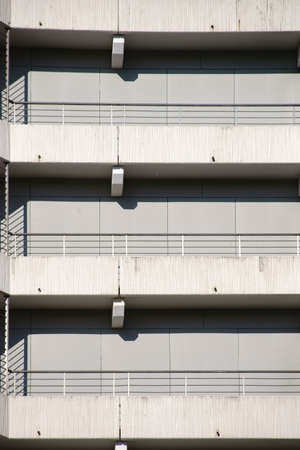 The different floors and levels of a parking garage with concrete stairs and concrete railing.                         の写真素材