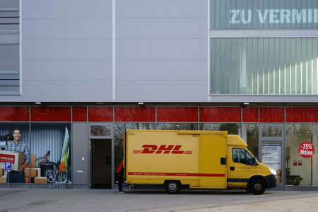 Mainz, Germany - November 14, 2017: A parcel delivery and delivery vehicle from DHL deliver packages on November 04, 2017 in Mainz.のeditorial素材