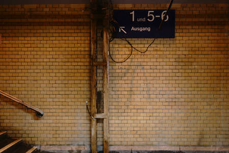 The exit of an old nostalgic station tunnel with tiled walls.                           
