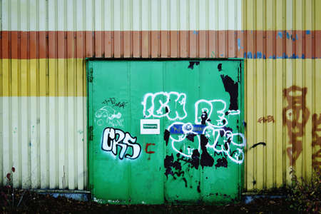 A graffiti painted steel door or fireproof door and emergency exit.                           の写真素材